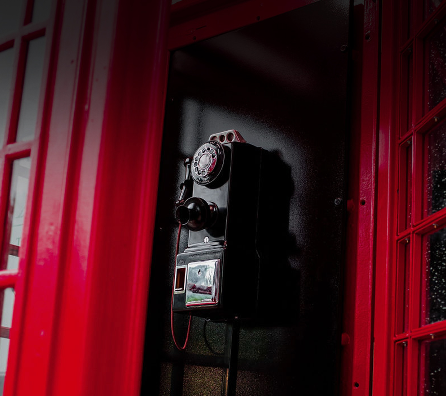 Vintage rotary telephone inside the Red Phone Booth
